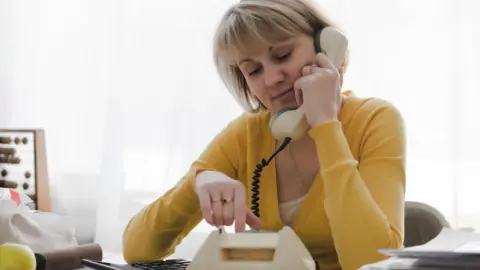 Getty Images woman on landline phone