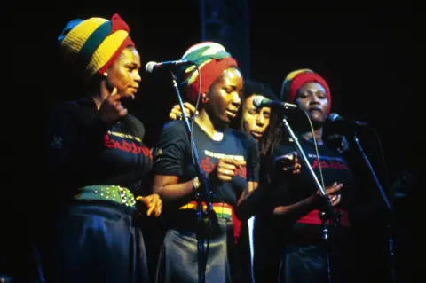 Getty Images Bob Marley and the I-Threes perform together at the Rainbow Theatre in London in 1977