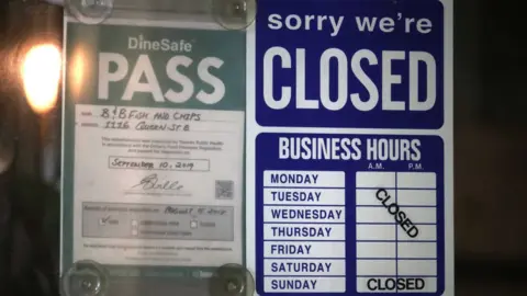 Toronto Star via Getty Images A business in Toronto shows a closed sign even as Ontario begins to slowly emerge from lockdown