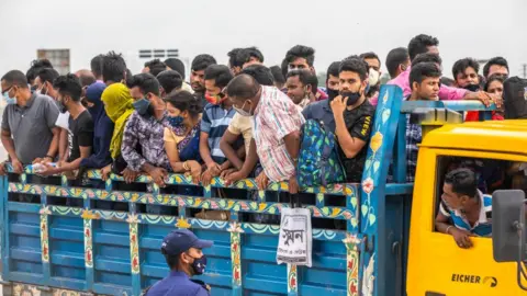 Getty Images People return to capital Dhaka as restrictions ease