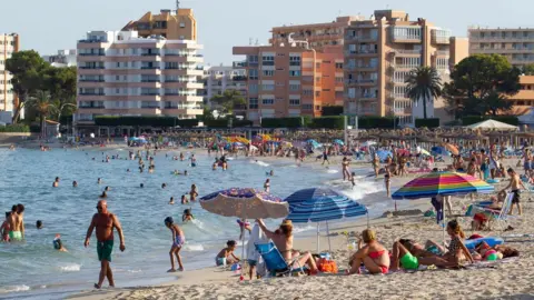 Reuters People sunbathing in Mallorca