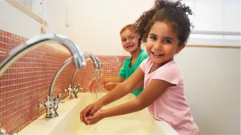 Getty Images Children washing hands in school