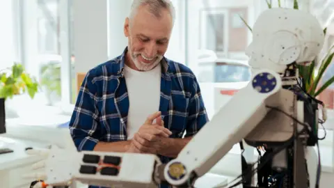 Getty Images Older person with robot