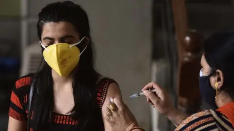 Getty Images A woman being vaccinated in Gurugram, India