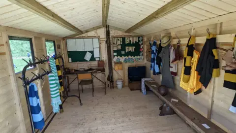 Beamish Museum Interior of the football cabin showing shirts and scarves