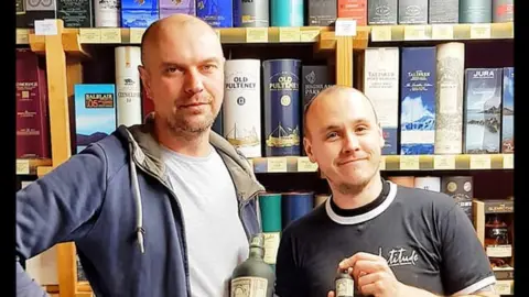 Chris Hill Chris Hill (left) and delivery driver Max