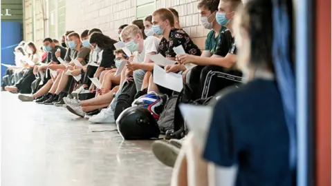 SASCHA STEINBACH/EPA Students at school wearing face coverings