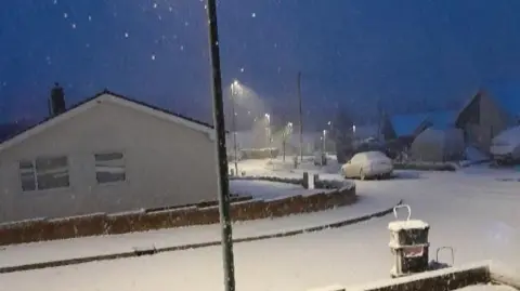 Rassauboyo/Weather Watchers Snow falls on a street in Ebbw Vale