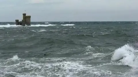 BBC Choppy seas around the Tower of Refuge, a small castle-like structure, in Douglas Bay.