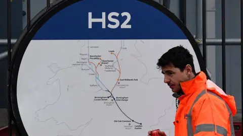 Reuters Construction worker in front of HS2 sign