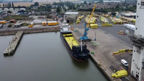 BBC/Shaun Whitmore Aerial image of timber being unloaded at King's Lynn Port