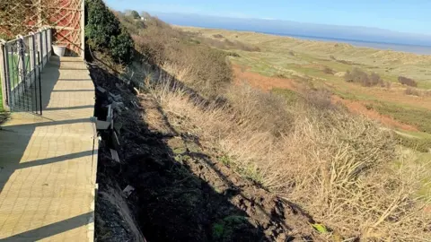 Raymond Cooper End of Raymond Cooper's garden showing landslip into dunes