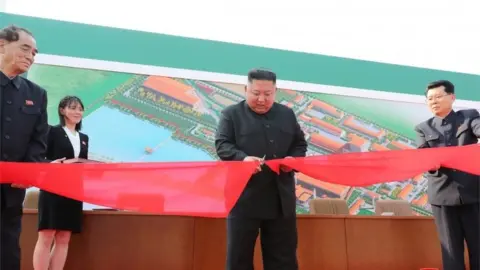 Reuters North Korea's leader Kim Jong-un pictured by state media opening a fertiliser factory on 1 May 2020