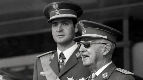 AFP A photo taken on June 10, 1971 shows Prince Juan Carlos of Bourbon (L) and Spanish Head of State General Francisco Franco (R) attending the Victory Parade in Madrid