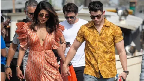 Getty Images Priyanka Chopra and husband Nick Jonas are seen as they disembarked from the boat 'Shivas' after a cruise, Paris, 2019