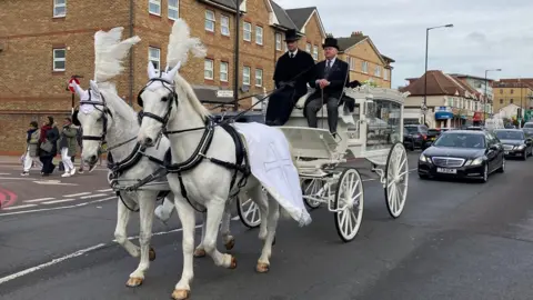 Horse-drawn carriage en route to Mr Kaba's funeral