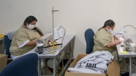 Getty Images Inmates in California sew Covid masks in April 2020