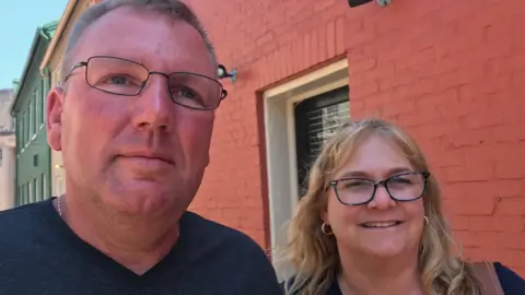 Pam Grimes and Doug Grimes - standing next to each other