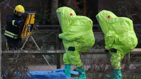 PA Firefighter at work while specialist officers walk past