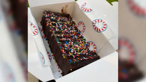 Get Baked A cake with sprinkles
