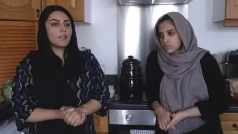 Shabhnam and her sister Meena in the kitchen of their new home