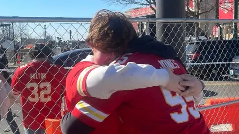 Two fans embrace