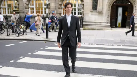 Getty Images Rory Stewart walks on a pedestrian crossing as he heads to the House of Commons