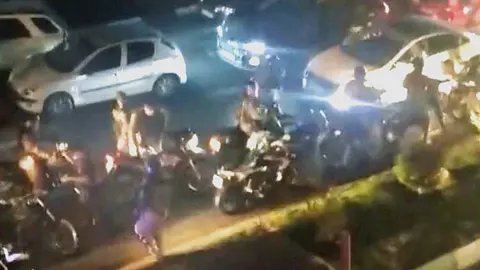 Screengrab of video showing people running during clashes between riot police as students in Tehran, Iran (2 October 2022)