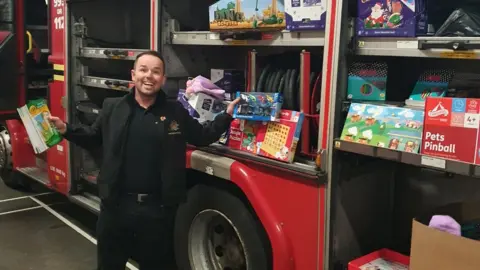 WMFS Darren Hutchinson with some of the presents