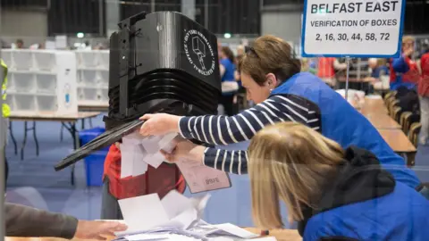 Pacemaker An electoral officer opens a ballot box at a Stormont election count centre in Belfast