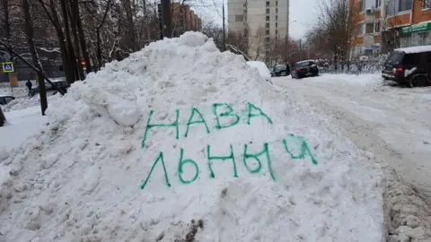 Tatyana Grigoryeva The name of Russian opposition leader Alexei Navalny spray-painted on a snow drift in Moscow.