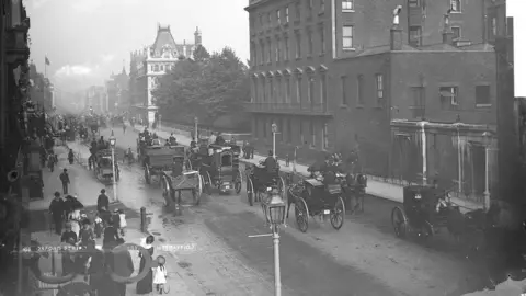 Historic England Archive Black and white image of horse-drawn cabs on Oxford Street taken in about 1890 to 1900