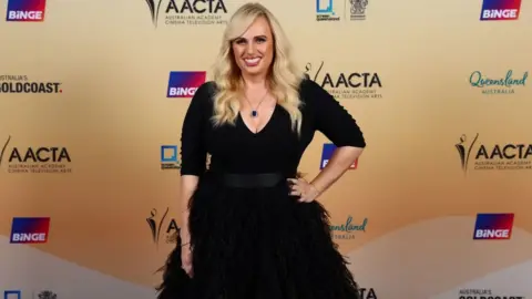 Getty Images Rebel Wilson in a black dress