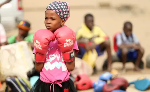 EPA A girl in pink boxing gloves in Lagos, Nigeria - Saturday 5 March 2022