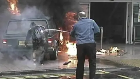 Off-duty police officer Stewart Ferguson hosed down the burning Kafeel Ahmed