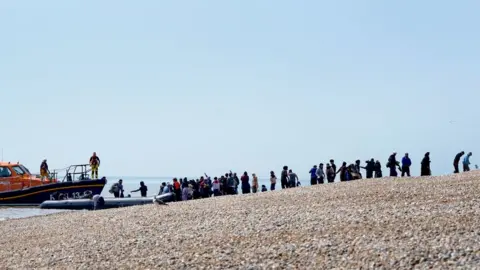 PA Media A large group arrives at Dungeness