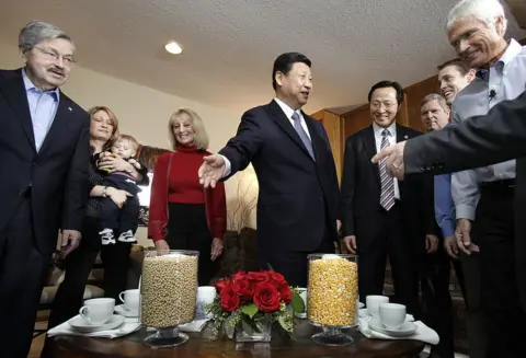 Getty Images Mr Xi looks at vases full of soybeans and corn in the Kimberly home in 2012 as Mr Branstad and Mr Kimberley look on