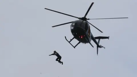 Andrew Matthews/PA John Bream jumps from helicopter
