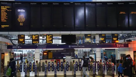 PA Media Blank train timetable display screens at Victoria train station, central London, as rail passengers are hit by disruption on the first working day of the year