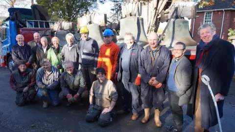 Dylan Parry Jones Church bell restoration committee in front of the bells