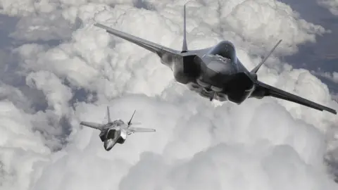 Getty Images Fighter jets in clouds