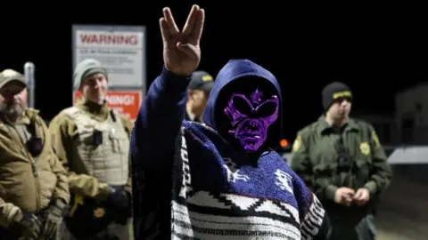 Reuters An attendee wears an alien mask at the gate of Area 51 as an influx of tourists responding to a call to "storm" Area 51