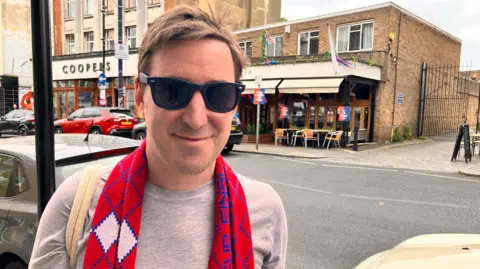Jamie Willard in a red scarf.