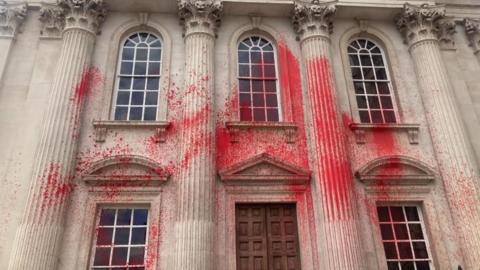 Red spray paint on Senate House, Cambridge