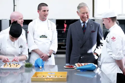 Getty Images The Prince of Wales meets young chefs participating in a programme at Dumfries House in May 2011 