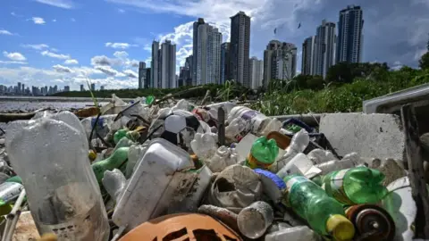 plastic waste with skyscrapers in background