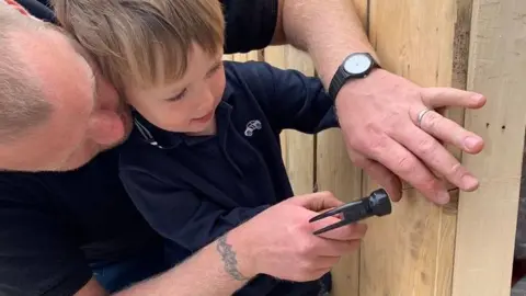 Kelly Jennison Eli and dad Ben doing DIY