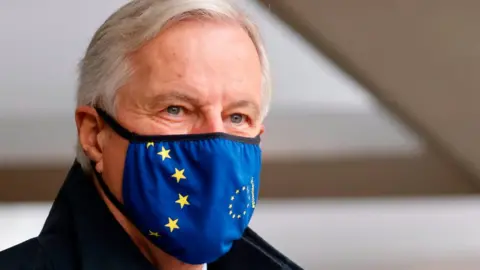 AFP EU chief negotiator Michel Barnier, wearing a mask, walks to a conference centre to continue negotiations on a trade deal between the EU and the UK in London on November 9, 2020.