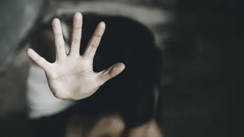 Getty Images Creative image of a young woman putting her hand out