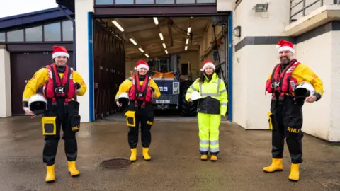 RNLI/Nathan Williams The Barber family outside the station